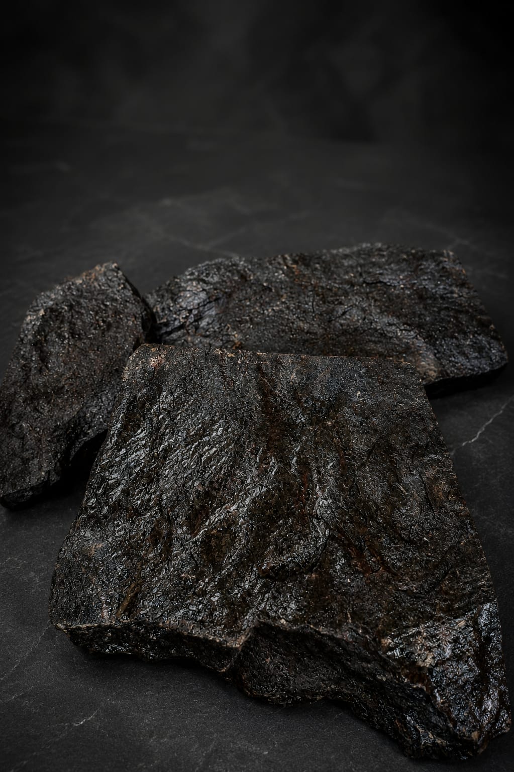Peças reais de Pedra Moledo Black com textura bruta em detalhe